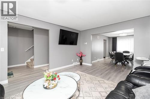 Gray wood-finish flooring throughout, complemented by light gray walls and white trim - 42 Saturn Road, Port Colborne, ON 