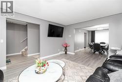 Gray wood-finish flooring throughout, complemented by light gray walls and white trim - 