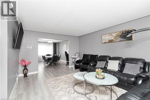 Wood-finish flooring throughout, with a framed opening leading to a dining area - 42 Saturn Road, Port Colborne, ON 