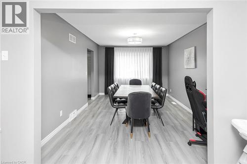 Recessed lighting, light gray wood-finish flooring, white trim, and a contemporary ceiling fixture - 42 Saturn Road, Port Colborne, ON 