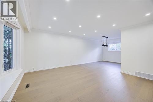 Recessed lighting, wood-finish flooring, bay window, crown molding, and pendant lighting fixture - 3148 Terraview Court, Burlington, ON 