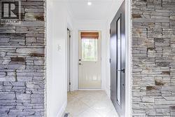 Stone veneer wall accents with crown molding detail - 