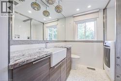 Double vanity with stone countertop and integrated farmhouse sink - 