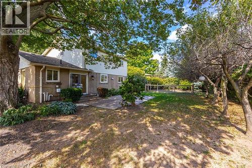 Brick and siding exterior with multiple windows and a sliding glass door - 3148 Terraview Court, Burlington, ON 