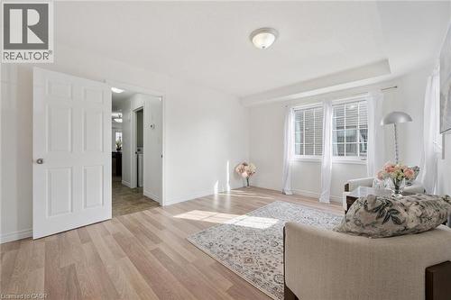 Recessed ceiling light, two large windows, wood-finish flooring, and white paneled doors - 931 Glasgow Street Unit# 27B, Kitchener, ON 