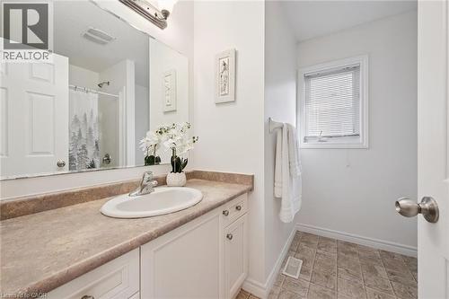 White vanity with brushed nickel hardware, integrated sink, and laminate countertop - 931 Glasgow Street Unit# 27B, Kitchener, ON 