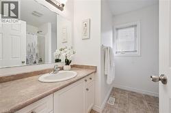 White vanity with brushed nickel hardware, integrated sink, and laminate countertop - 