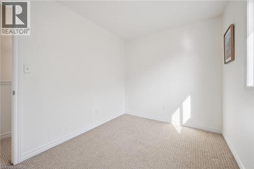 Neutral tone wall finishes, light-toned carpeting, and a window with natural light - 931 Glasgow Street Unit# 27B, Kitchener, ON 