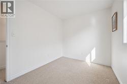 Neutral tone wall finishes, light-toned carpeting, and a window with natural light - 