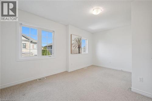 Neutral carpeting, white walls, and a multi-pane window - 931 Glasgow Street Unit# 27B, Kitchener, ON 
