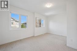 Neutral carpeting, white walls, and a multi-pane window - 