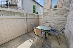 Private patio featuring concrete flooring and a lattice-top privacy fence - 