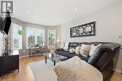 Recessed lighting, wood-finish flooring, and multiple windows with plantation shutters - 