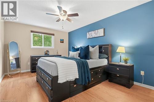 Wood-finish flooring throughout, complemented by a ceiling fan with light fixture - 94 Kent Road, Brantford, ON 