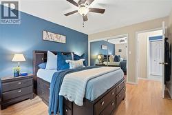 Wood-finish flooring throughout, complemented by a ceiling fan with integrated lighting - 