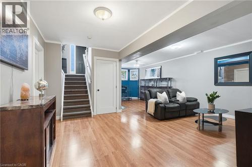 Wood-finish flooring, recessed lighting, white interior doors, and a carpeted staircase - 94 Kent Road, Brantford, ON 