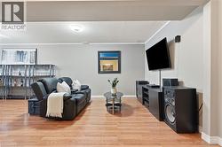 Wood-finish flooring throughout, complemented by light gray wall tones - 