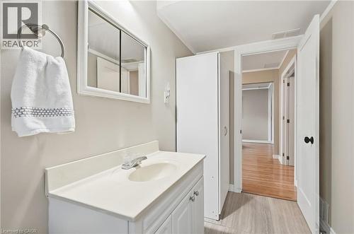Vanity with integrated sink, framed mirror, and chrome faucet - 94 Kent Road, Brantford, ON 