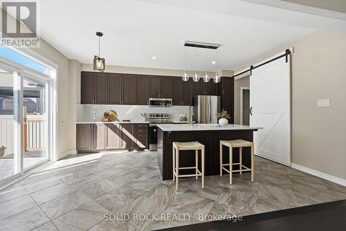 Spacious kitchen with a stylish barn door - 55 Solaris Drive, Ottawa, ON 