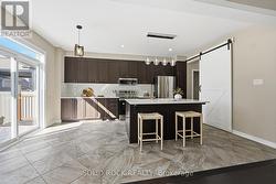 Spacious kitchen with a stylish barn door - 