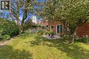 Expansive lawn bordered by mature trees and established shrubs - 152 Hilda Avenue, North York, ON 
