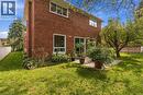 Brick exterior, multiple windows, sliding glass door, paved patio, mature tree - 152 Hilda Avenue, North York, ON 