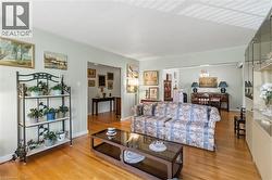 Hardwood flooring throughout, light-toned wall paint, and a built-in display cabinet with mirrored backing - 