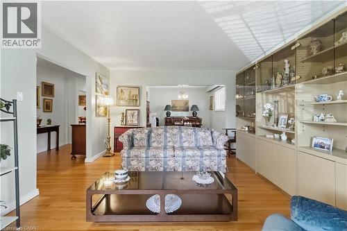Hardwood flooring, recessed lighting, built-in display cabinetry with glass fronts, built-in lower cabinetry, and cased openings - 152 Hilda Avenue, North York, ON 