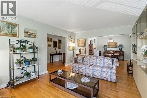 Hardwood flooring throughout, light-toned wall paint, and a built-in display cabinet with mirrored backing - 152 Hilda Avenue, North York, ON 