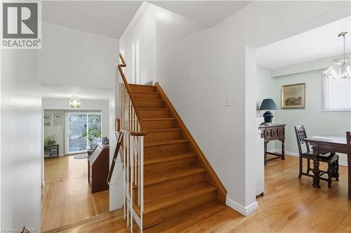 Hardwood flooring, wood staircase with white balusters, and a sliding glass door - 152 Hilda Avenue, North York, ON 