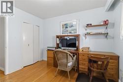 Wood-finish flooring, light-toned wall paint, and a built-in double-door closet - 