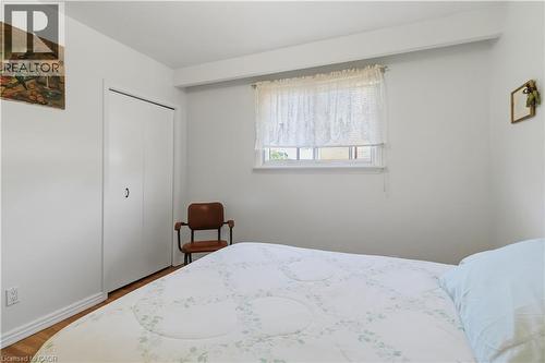 White walls with a single window, bi-fold closet doors, and wood-finish flooring - 152 Hilda Avenue, North York, ON 