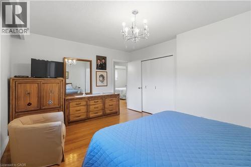 Hardwood flooring, crisp white walls, contemporary chandelier, and bi-fold closet doors - 152 Hilda Avenue, North York, ON 