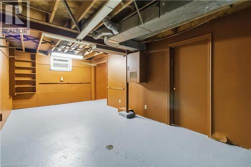 Finished basement space featuring exposed ceiling joists, built-in shelving, a single window, and painted concrete flooring - 152 Hilda Avenue, North York, ON 