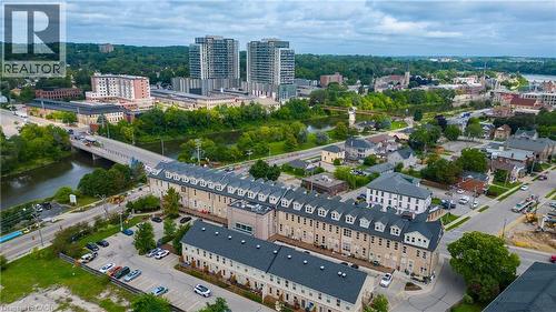 Aerial perspective showcasing urban residential buildings, proximity to a river, and surrounding green spaces - 25 Concession Street Unit# 110, Cambridge, ON 