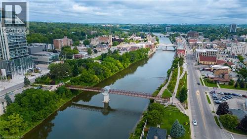 Riverfront urban setting with multiple bridges, mature trees, and diverse architectural styles - 25 Concession Street Unit# 110, Cambridge, ON 