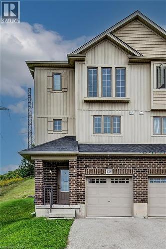 Brick and siding exterior with an attached garage, covered entryway, and asphalt shingle roof - 226 Maitland Street, Kitchener, ON 
