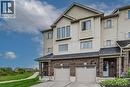 Modern two-story home featuring a brick and siding exterior with a peaked roofline, double garage with white paneled doors, and multi-pane windows throughout - 226 Maitland Street, Kitchener, ON 