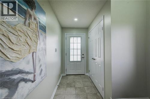 Entryway featuring tiled flooring, recessed lighting, a paneled door with glass inserts, and bifold closet doors - 226 Maitland Street, Kitchener, ON 