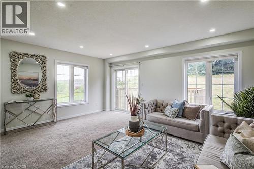Recessed ceiling lighting, light-toned carpeting, multiple windows, and a glass sliding door - 226 Maitland Street, Kitchener, ON 