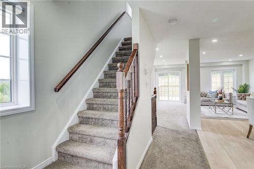 Carpeted staircase with wood handrail, recessed lighting, and light wood-finish flooring - 226 Maitland Street, Kitchener, ON 