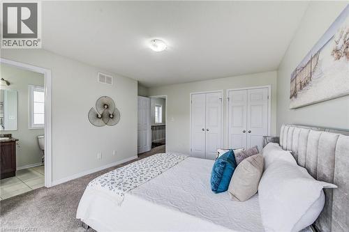 Carpeted flooring, light-toned walls, and twin bi-fold closet doors - 226 Maitland Street, Kitchener, ON 