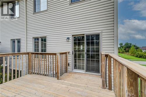 Exterior featuring horizontal siding, a private wood-finish deck, and a sliding glass door with grid detailing - 226 Maitland Street, Kitchener, ON 