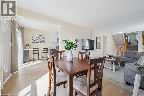 Dining room with light wood finished floors and stairway - 47 Mccurdy Road, Guelph, ON 