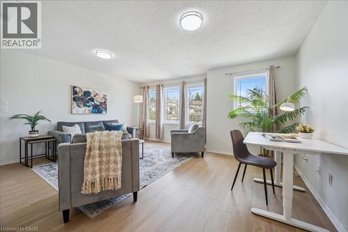 Living area featuring light wood-style flooring and a textured ceiling - 47 Mccurdy Road, Guelph, ON 