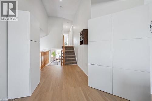 Hallway featuring light wood-style floors, stairs, and recessed lighting - 47 Mccurdy Road, Guelph, ON 