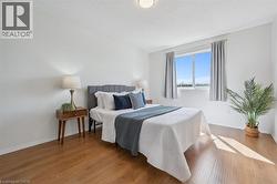 Bedroom featuring wood finished floors and a textured ceiling - 
