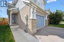 View of side of home with brick siding, asphalt driveway, and an attached garage - 47 Mccurdy Road, Guelph, ON 