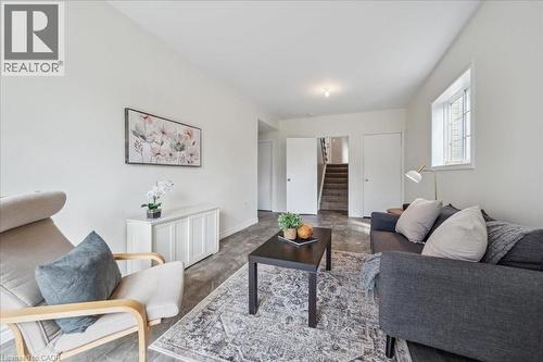 Living area featuring stairs and baseboards - 47 Mccurdy Road, Guelph, ON 