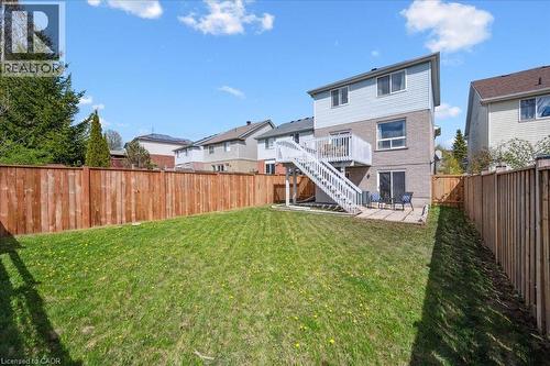 Rear view of house with a patio area, a fenced backyard, stairs, a residential view, and brick siding - 47 Mccurdy Road, Guelph, ON 